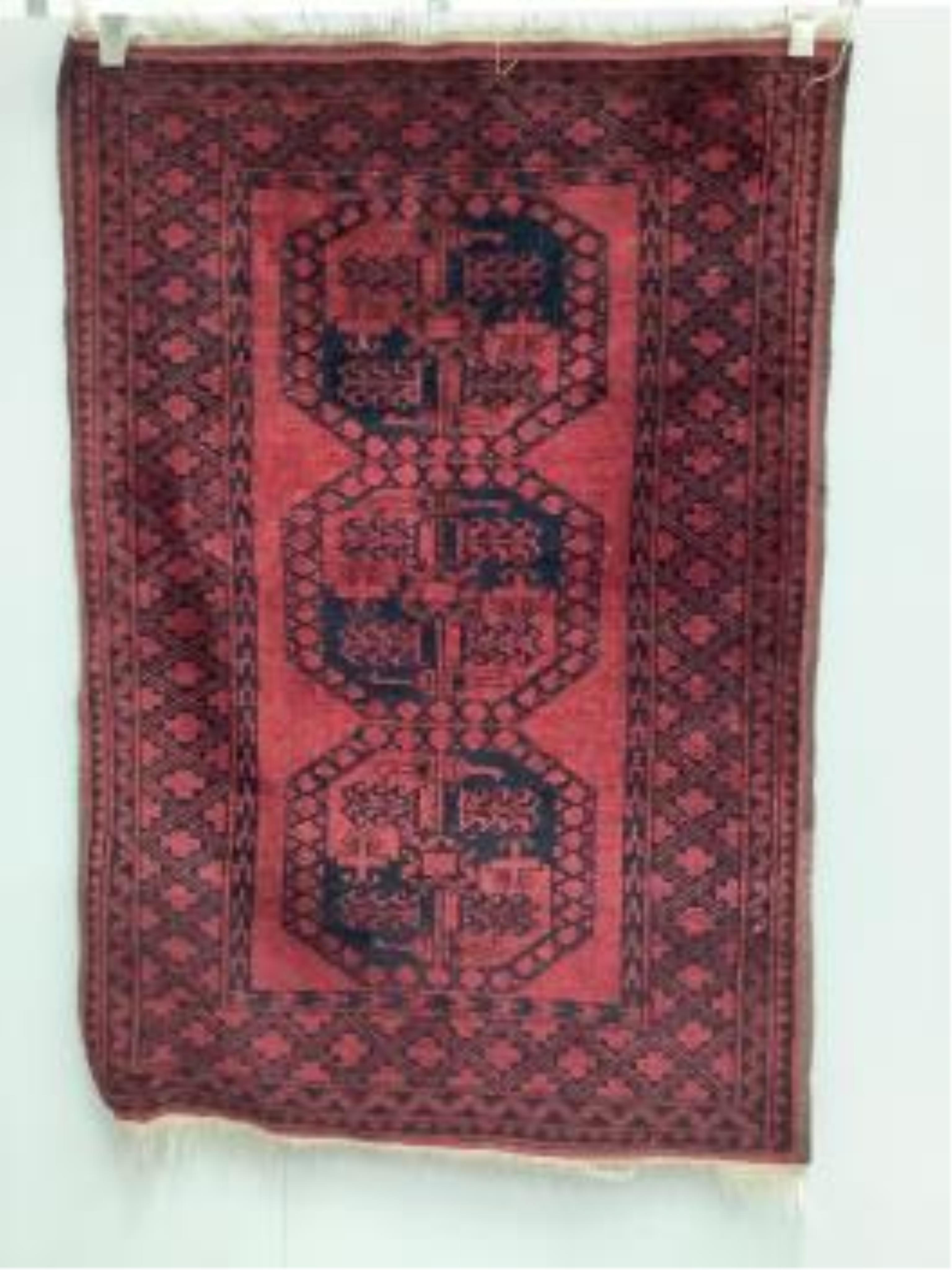 Two Afghan red ground rugs, largest 170 x 120cm. Condition - fair